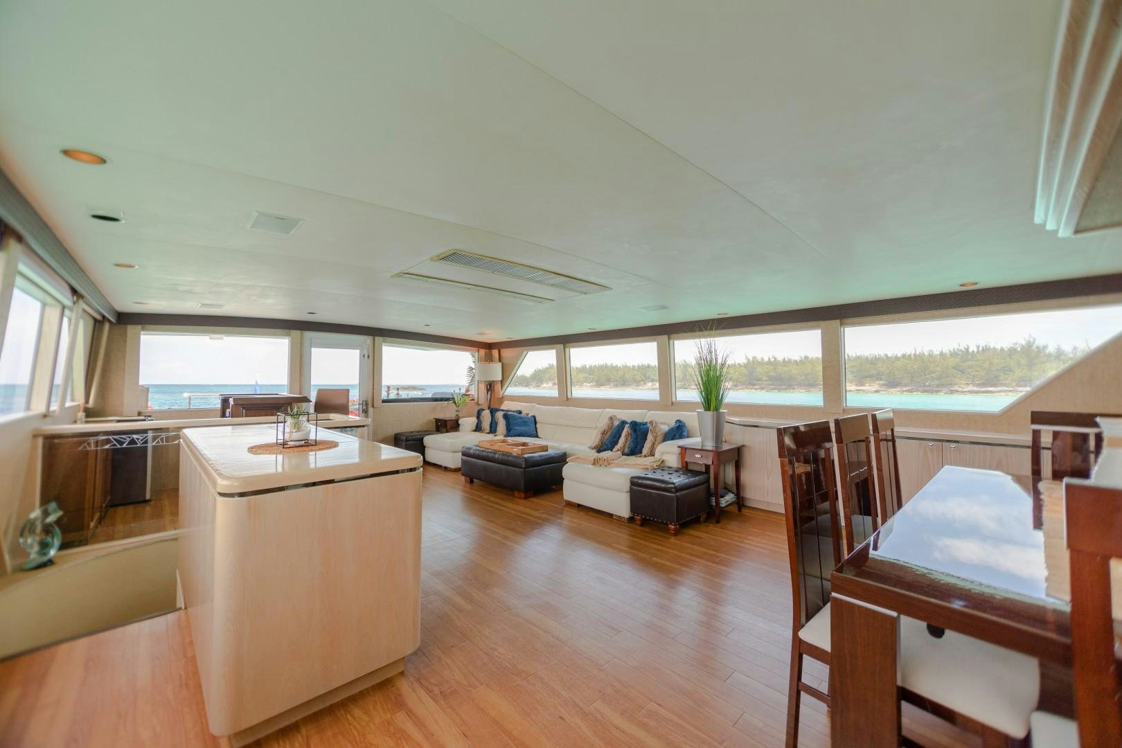 a large living room with a large balcony aboard ISLAND TIME Yacht for Sale