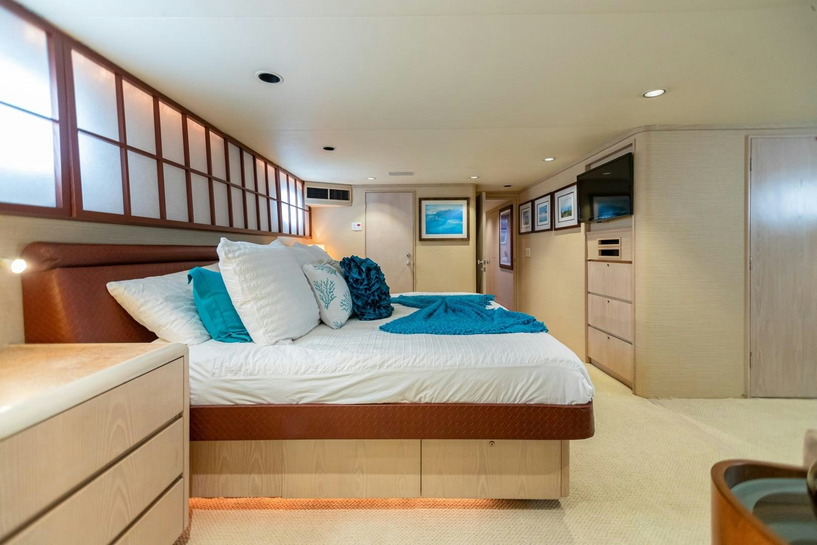 a bedroom with a bed and a tv on the wall aboard ISLAND TIME Yacht for Sale