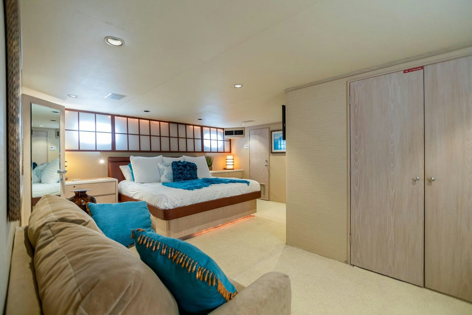 a bedroom with a bed and a closet aboard ISLAND TIME Yacht for Sale