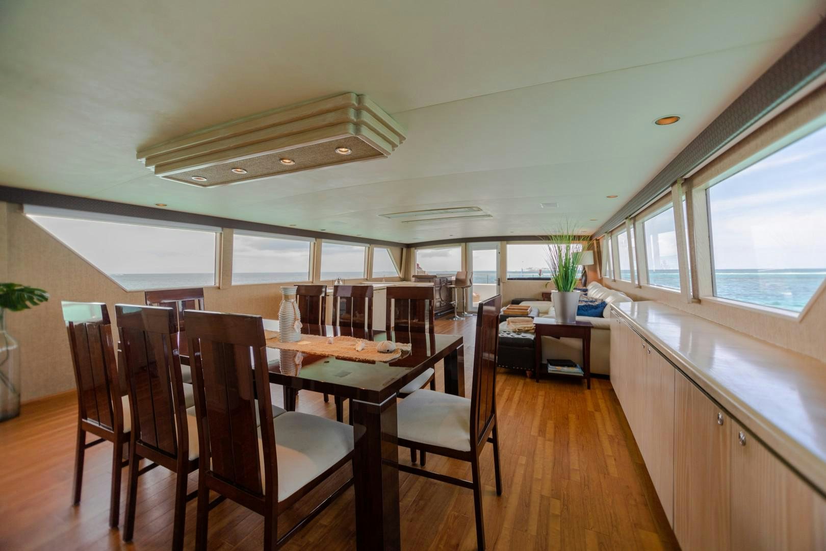 a dining room with wood floors aboard ISLAND TIME Yacht for Sale