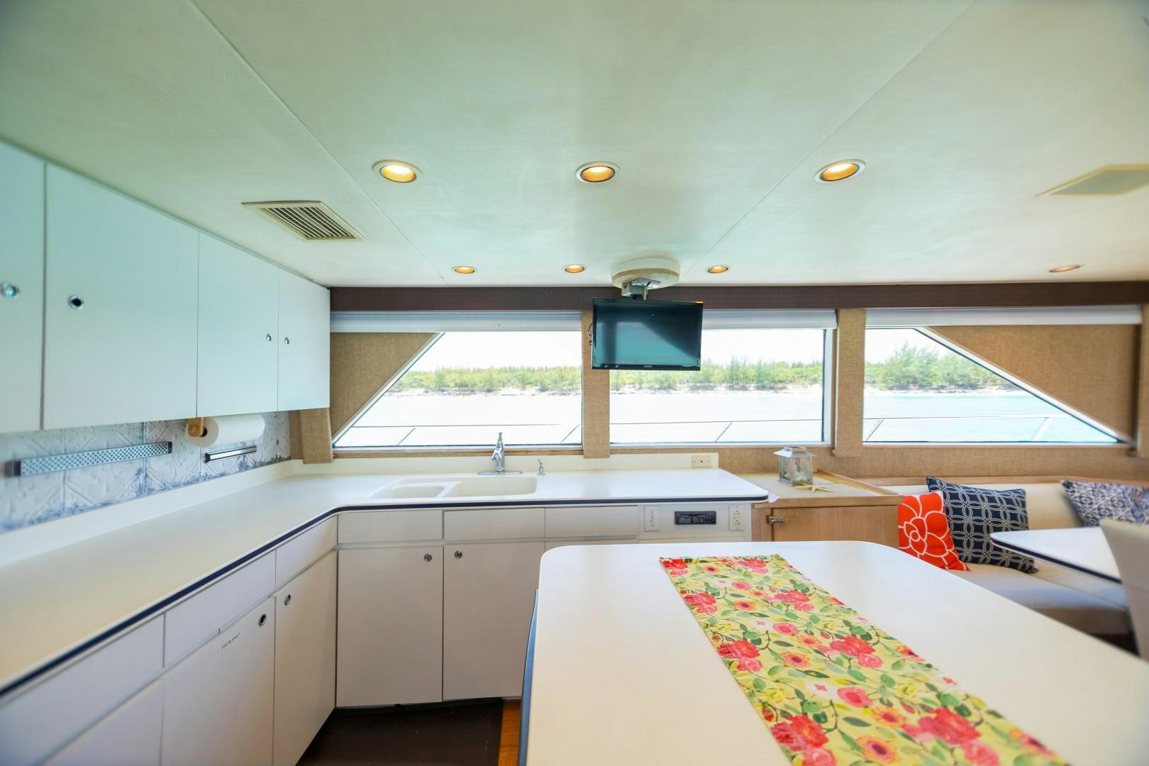 a kitchen with a table and a tv aboard ISLAND TIME Yacht for Sale