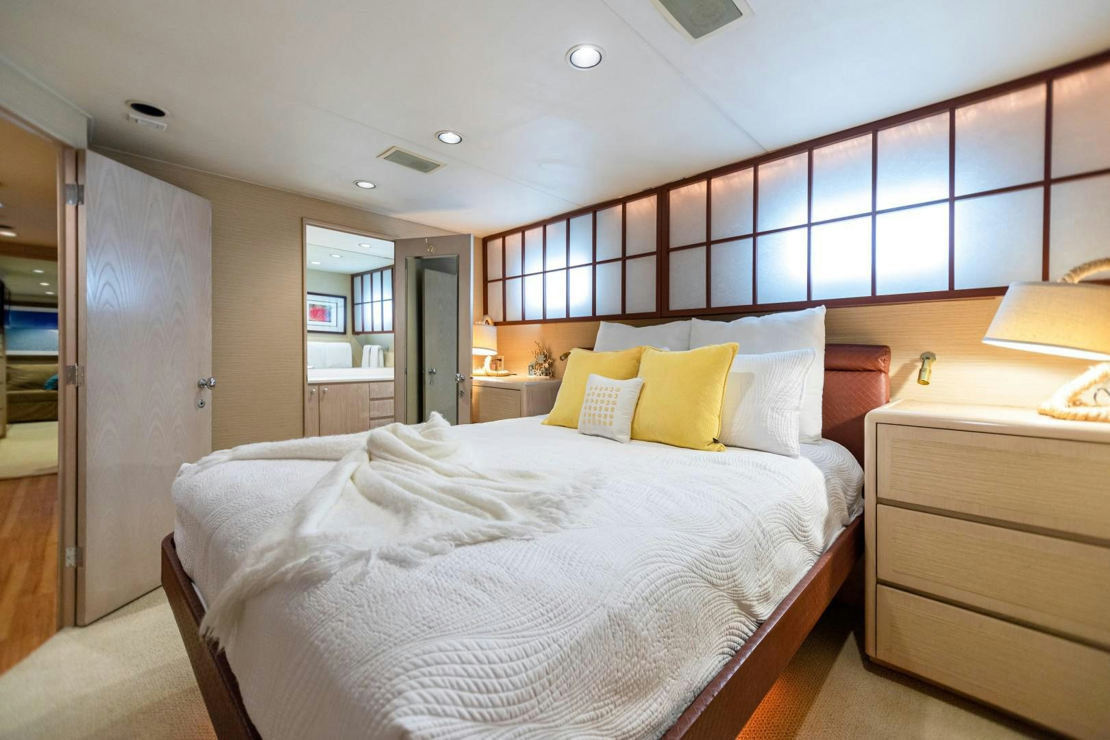 a bedroom with a bed and a desk aboard ISLAND TIME Yacht for Sale