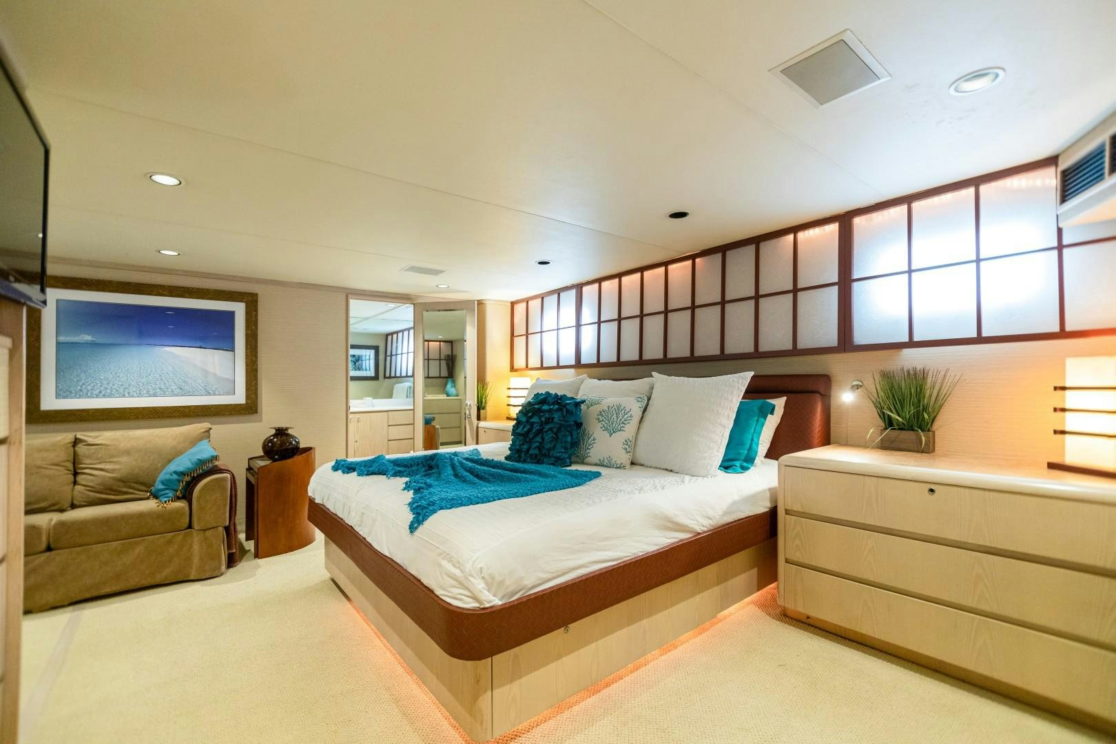 a bedroom with a bed and a couch aboard ISLAND TIME Yacht for Sale