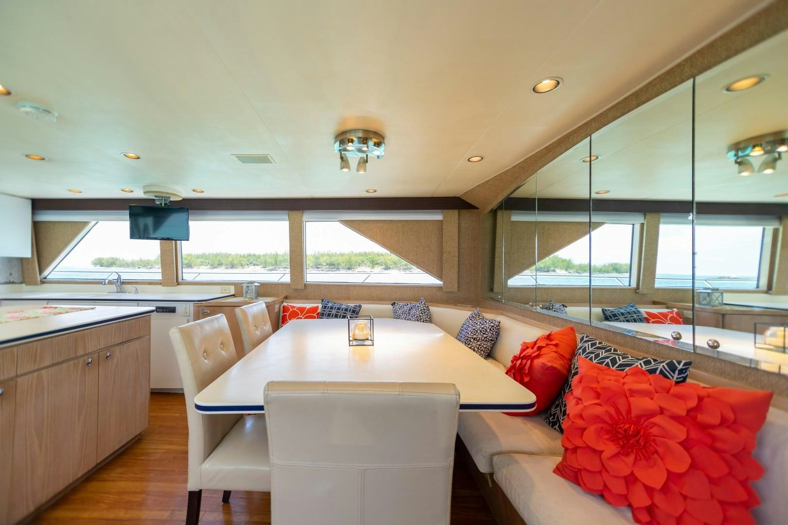 a large living room with a large table and chairs aboard ISLAND TIME Yacht for Sale