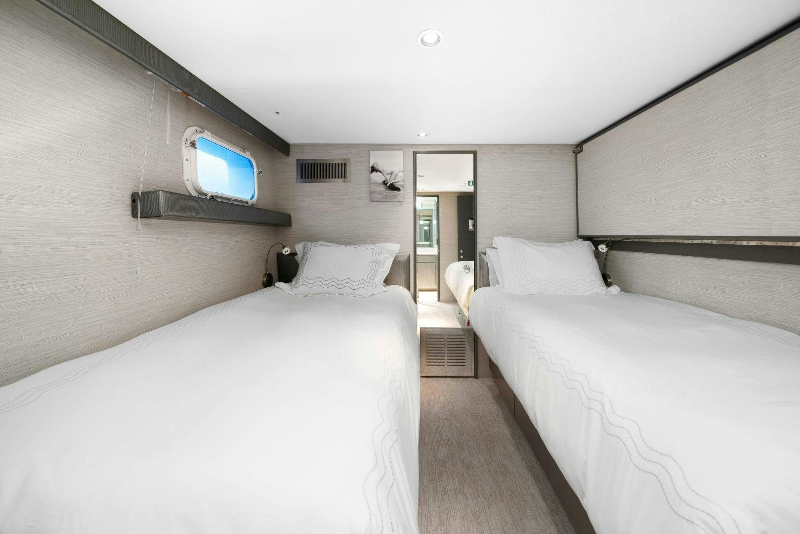 a room with two beds aboard EXIT STRATEGY Yacht for Sale