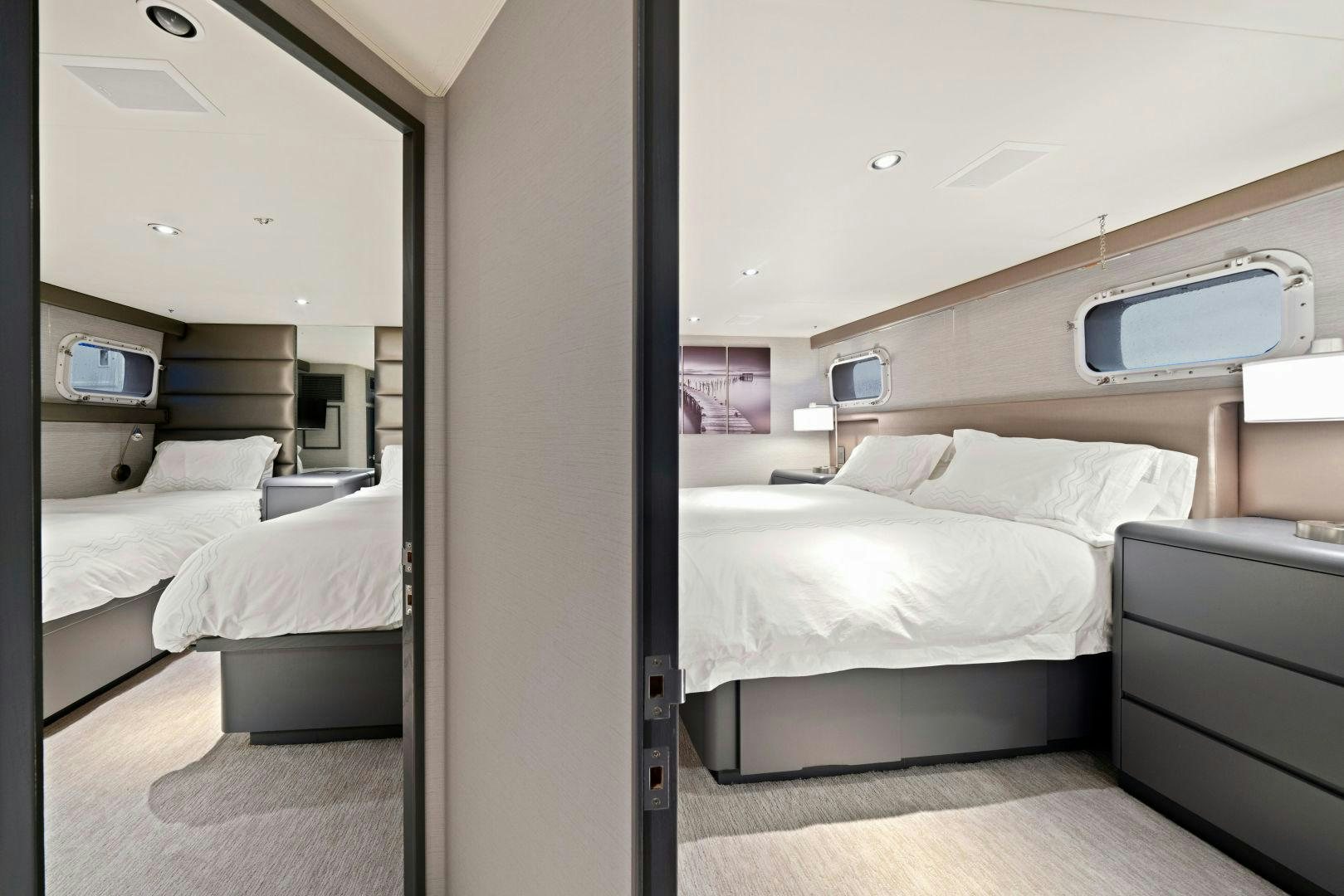 a room with a bed and a television aboard EXIT STRATEGY Yacht for Sale