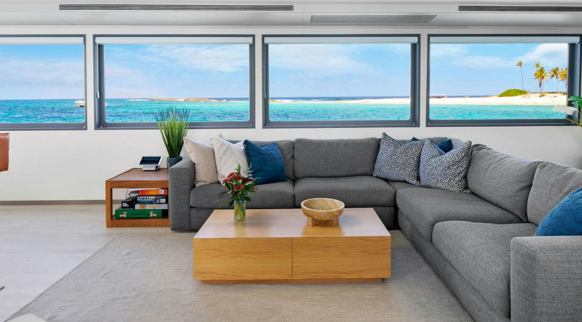 a living room with a couch and a coffee table aboard EXIT STRATEGY Yacht for Sale