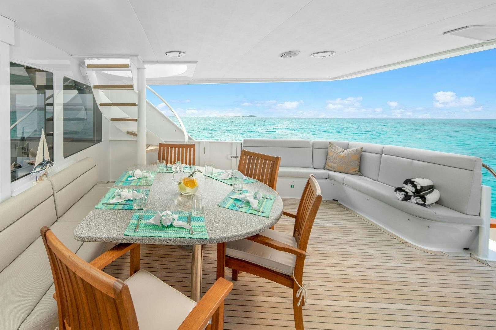 a table and chairs on a balcony aboard EXIT STRATEGY Yacht for Sale
