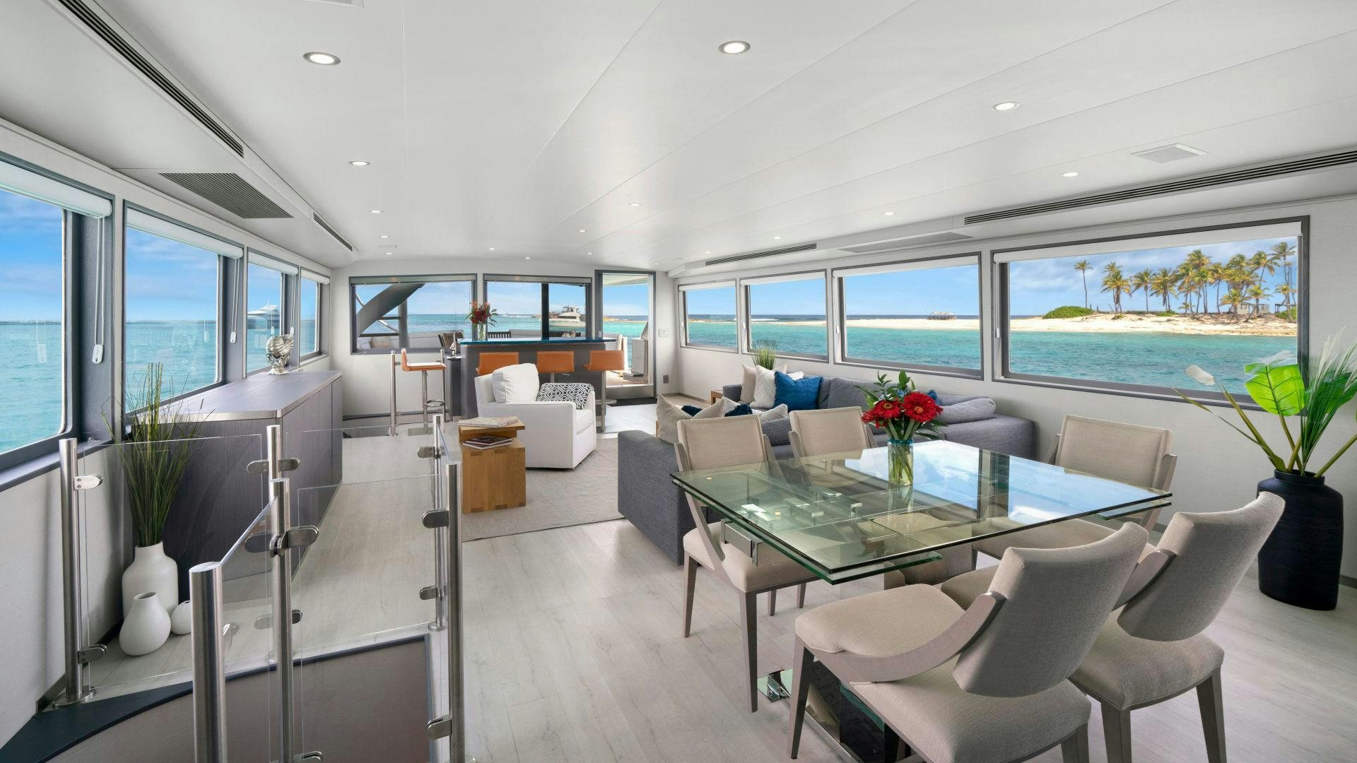 a large room with a table and chairs aboard EXIT STRATEGY Yacht for Sale