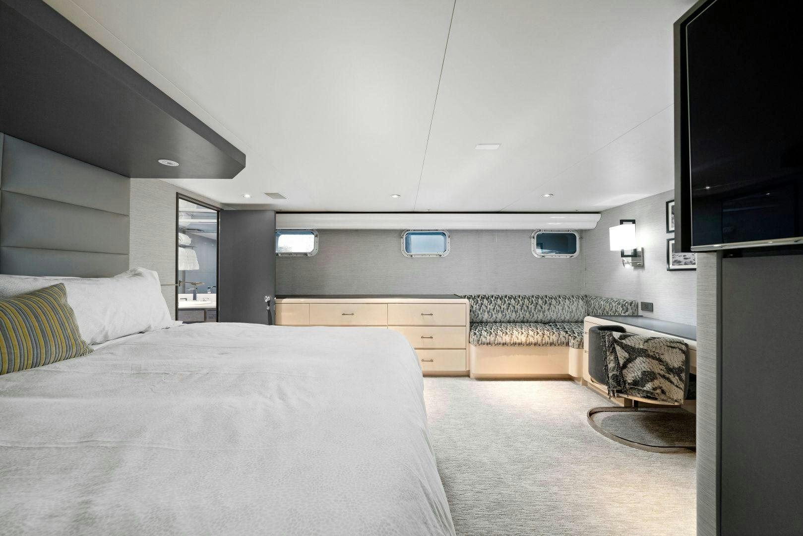 a bedroom with a bed and a tv aboard EXIT STRATEGY Yacht for Sale