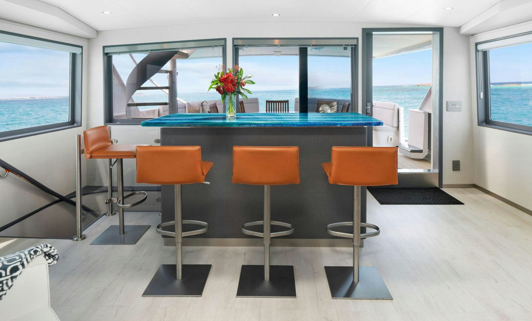 a room with a pool table and chairs aboard EXIT STRATEGY Yacht for Sale