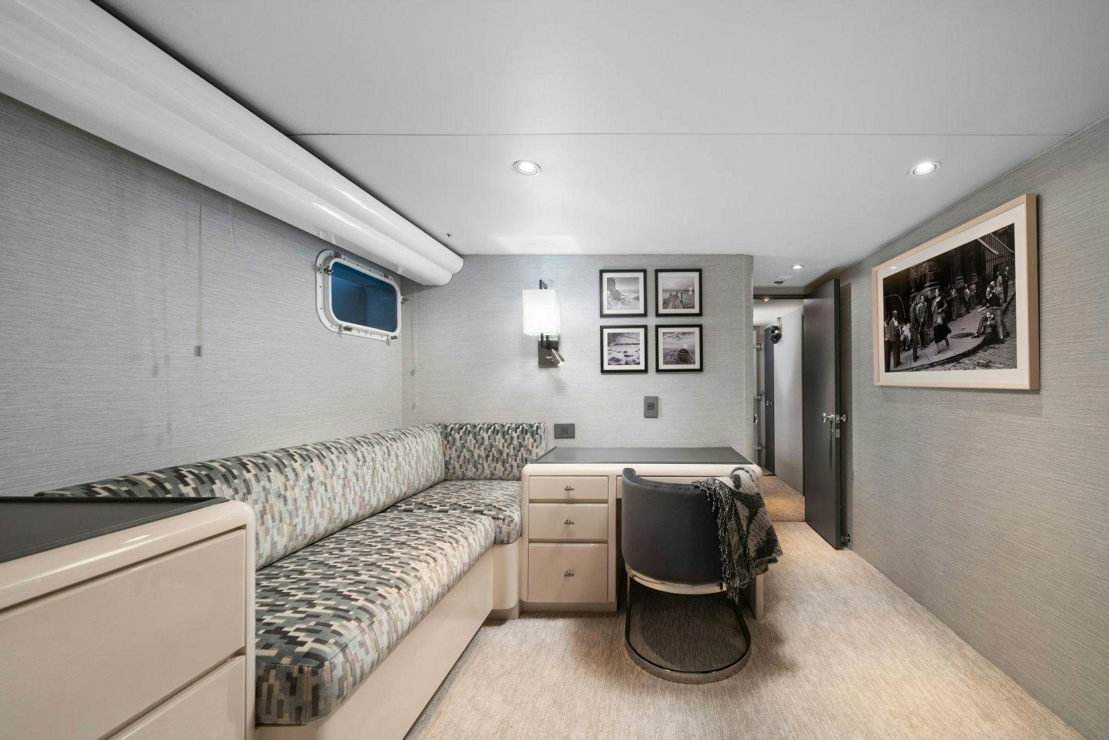 a bedroom with a bed and a chair aboard EXIT STRATEGY Yacht for Sale
