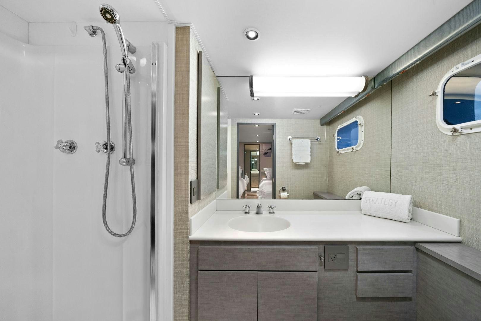 a bathroom with a sink and a mirror aboard EXIT STRATEGY Yacht for Sale