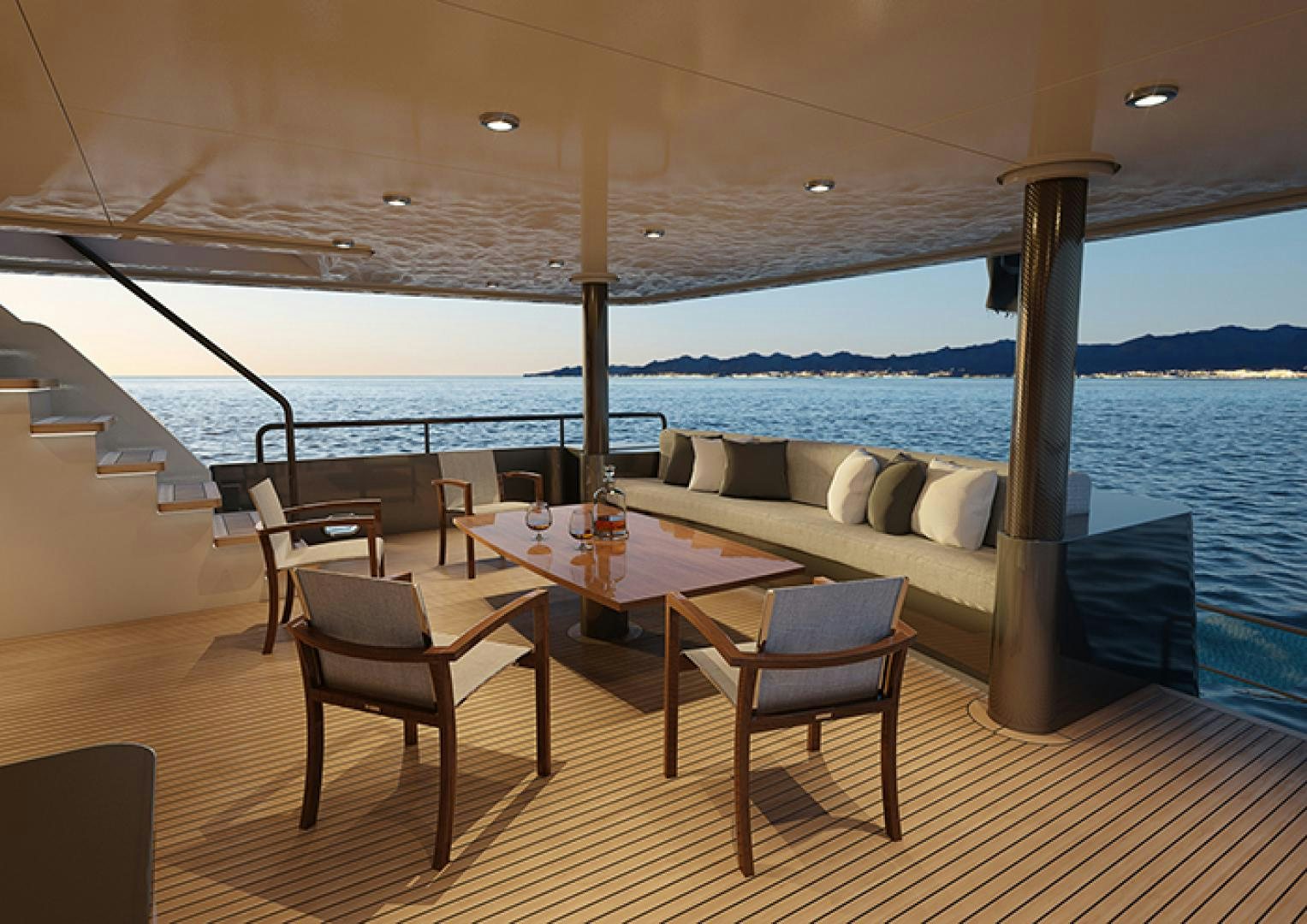 a table and chairs on a deck overlooking a body of water aboard CRESCENT 110 Yacht for Sale