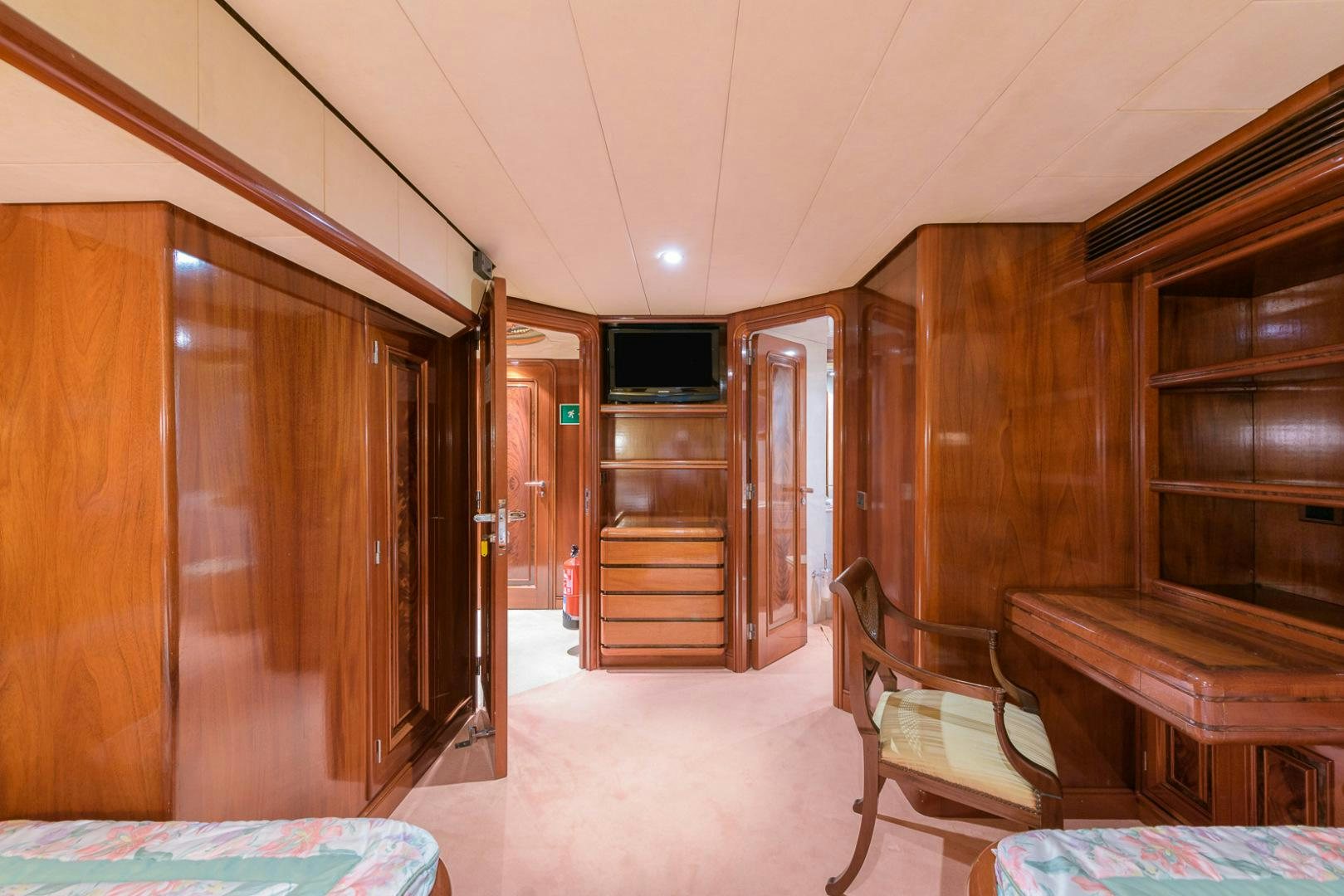 a room with wooden furniture aboard ELBA Yacht for Sale