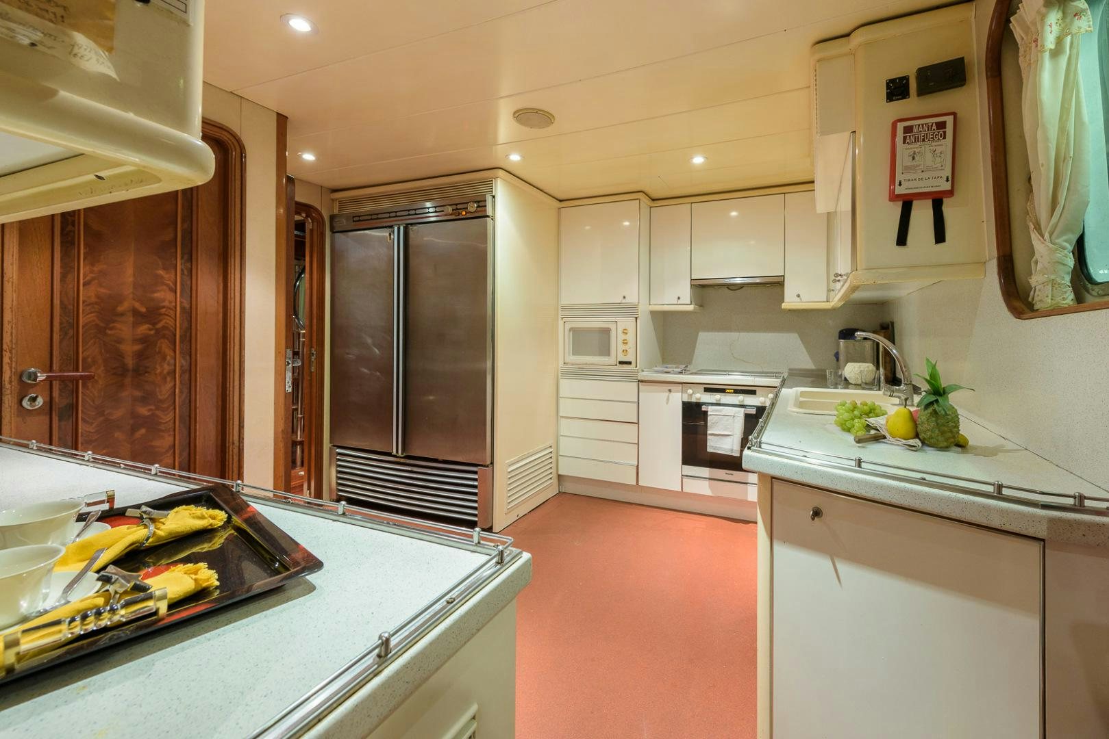 a kitchen with white cabinets aboard ELBA Yacht for Sale