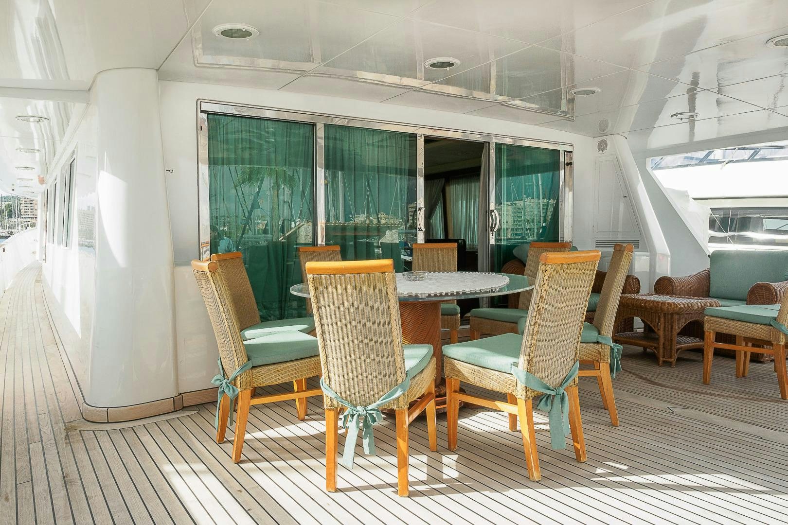 a room with tables and chairs aboard ELBA Yacht for Sale