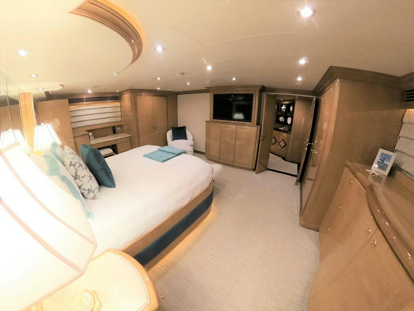 a bedroom with a bed and a television aboard SEAS THE DAY Yacht for Sale
