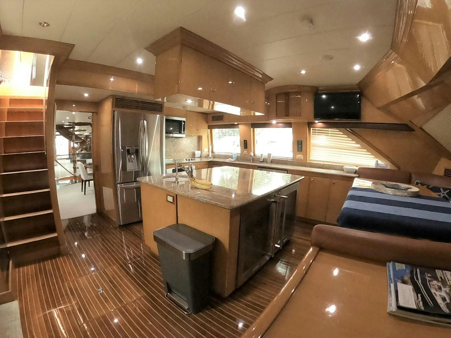 a kitchen with a large island aboard SEAS THE DAY Yacht for Sale