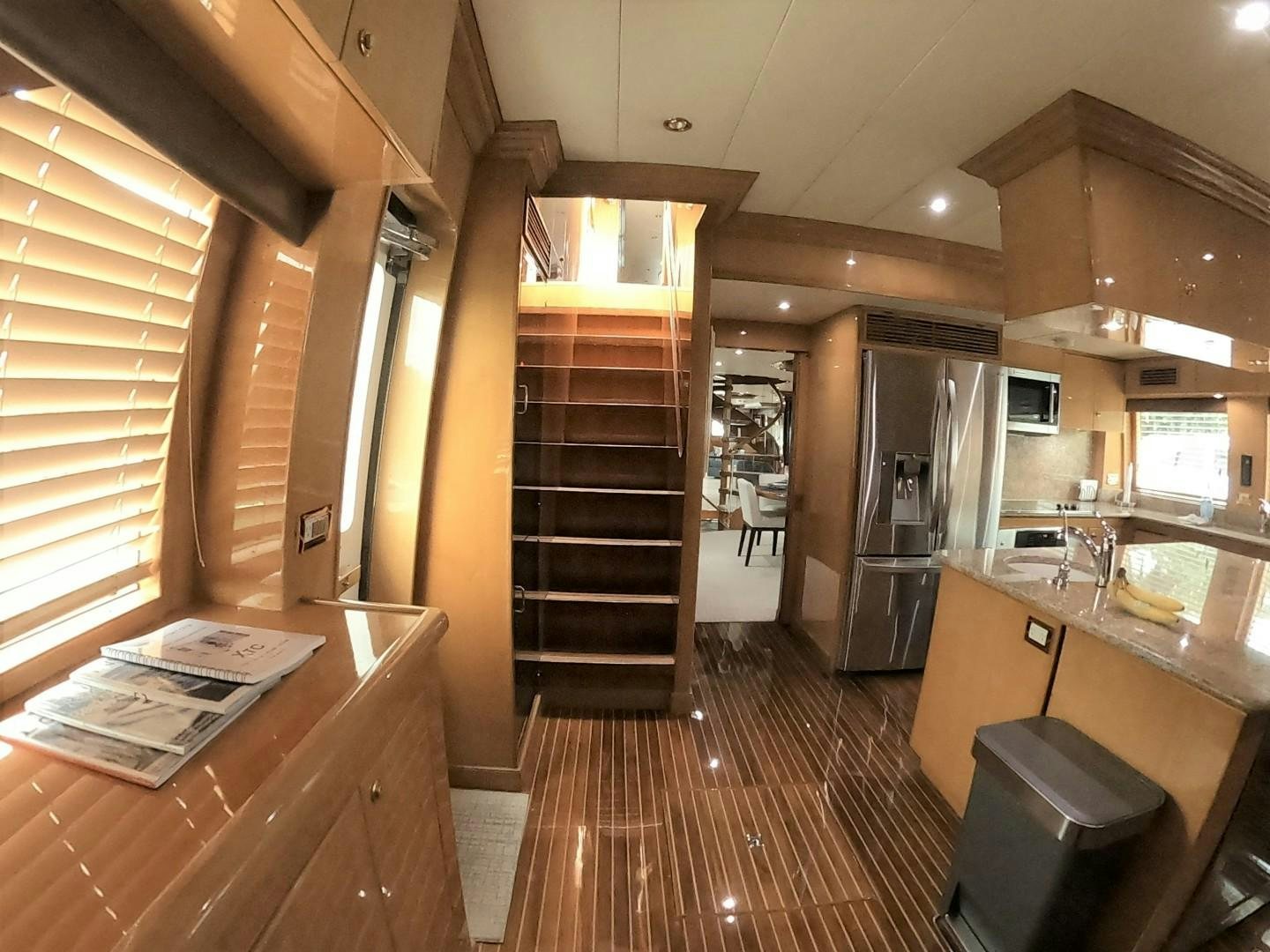 a kitchen with a refrigerator and a microwave oven aboard SEAS THE DAY Yacht for Sale