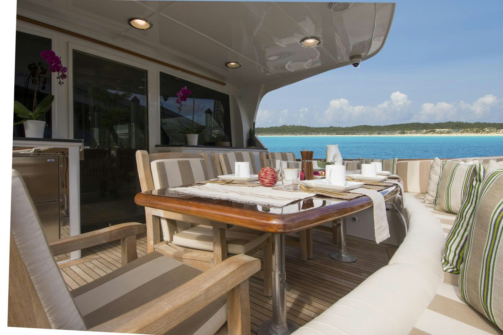 a table and chairs in a room aboard KALEEN Yacht for Sale