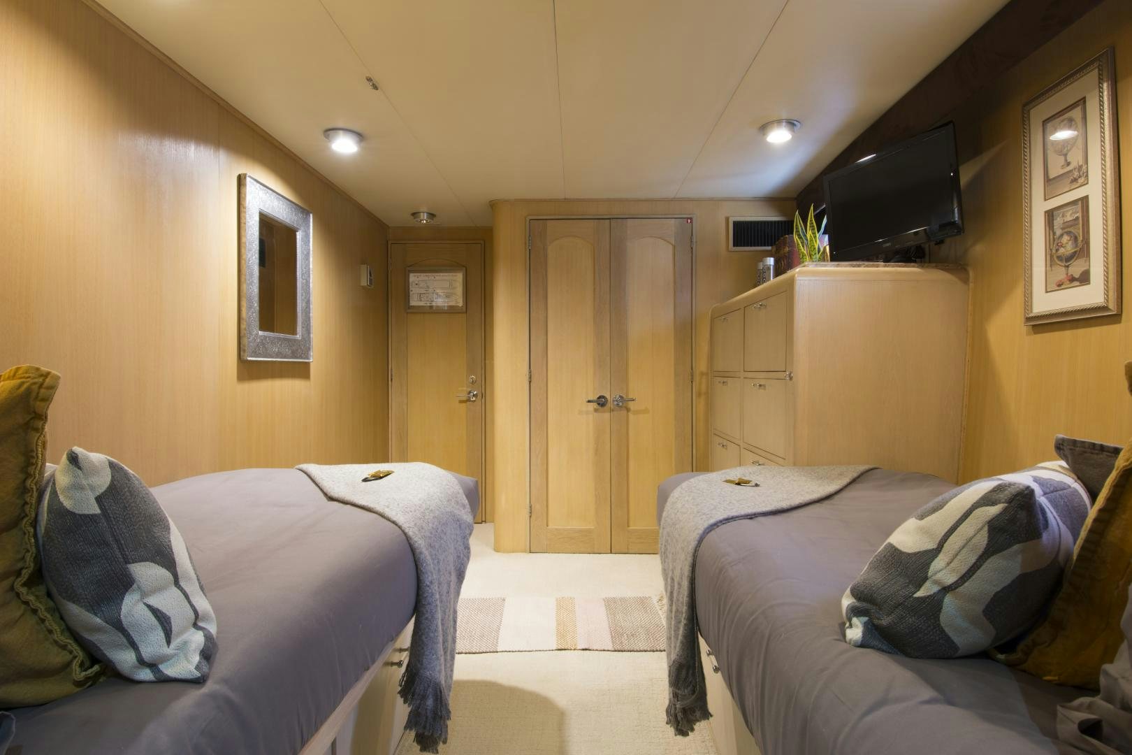 a bedroom with two beds aboard KALEEN Yacht for Sale