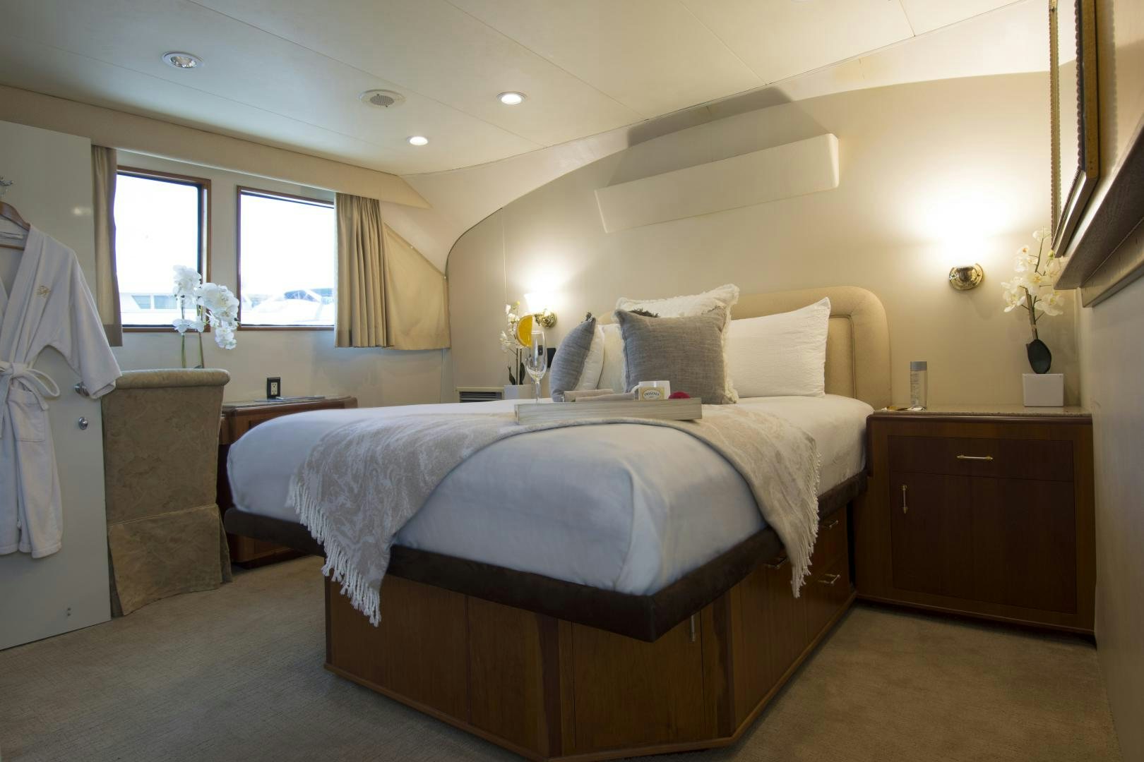 a bedroom with a bed and a window aboard KALEEN Yacht for Sale