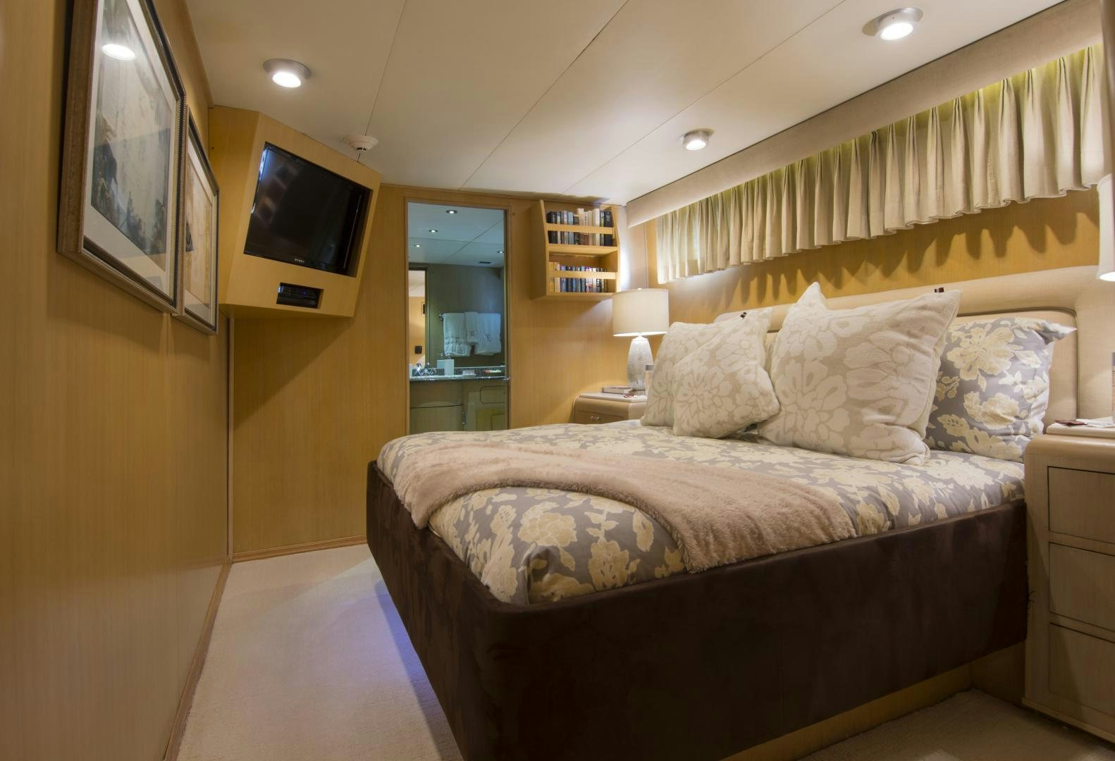 a bedroom with a bed and a television aboard KALEEN Yacht for Sale