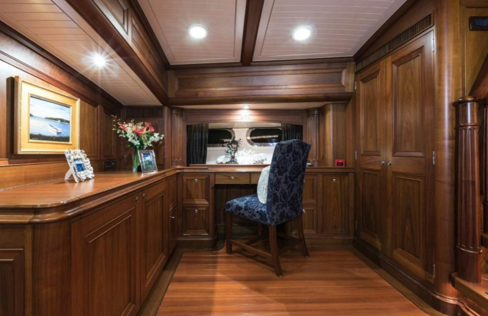 a kitchen with a blue chair aboard MARAE Yacht for Sale