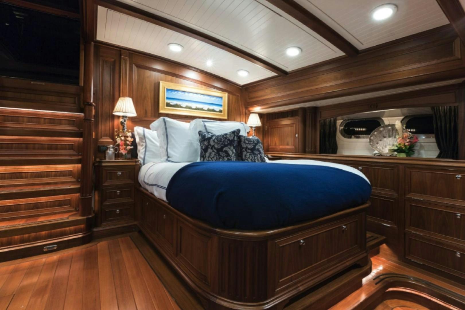 a bedroom with a bed and a desk aboard MARAE Yacht for Sale