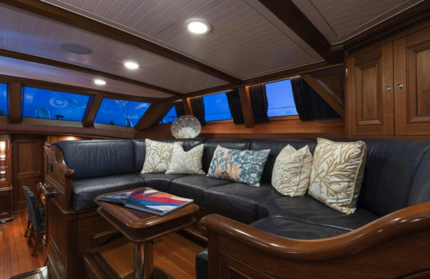 a living room with a leather couch aboard MARAE Yacht for Sale