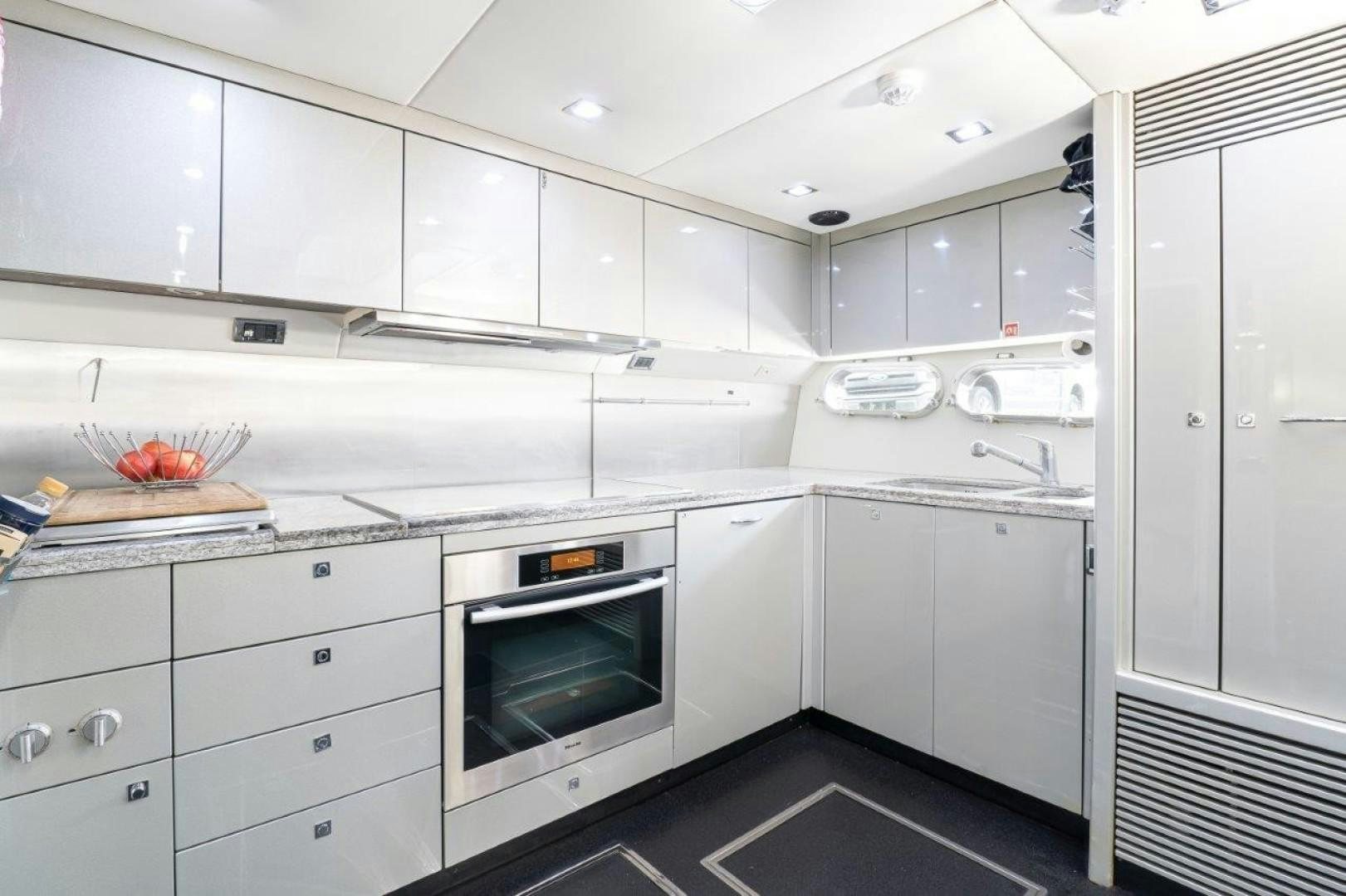 a kitchen with white cabinets aboard DOUBLE D Yacht for Sale