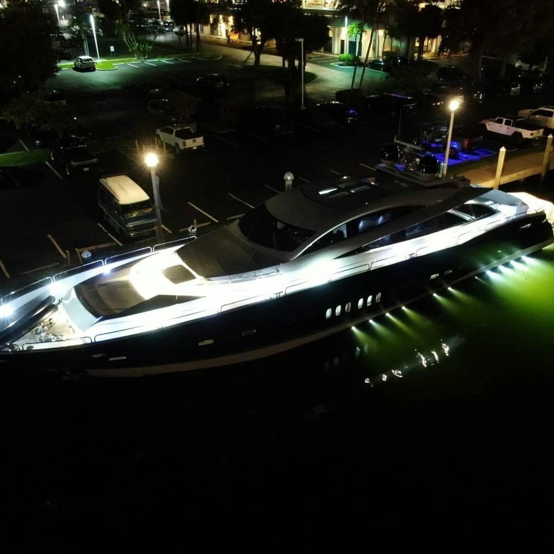 a white car parked on a street at night aboard DOUBLE D Yacht for Sale