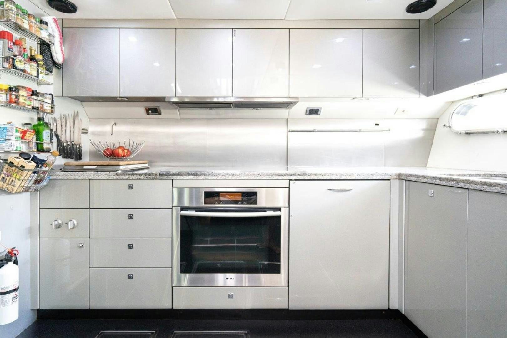 a kitchen with white cabinets aboard DOUBLE D Yacht for Sale