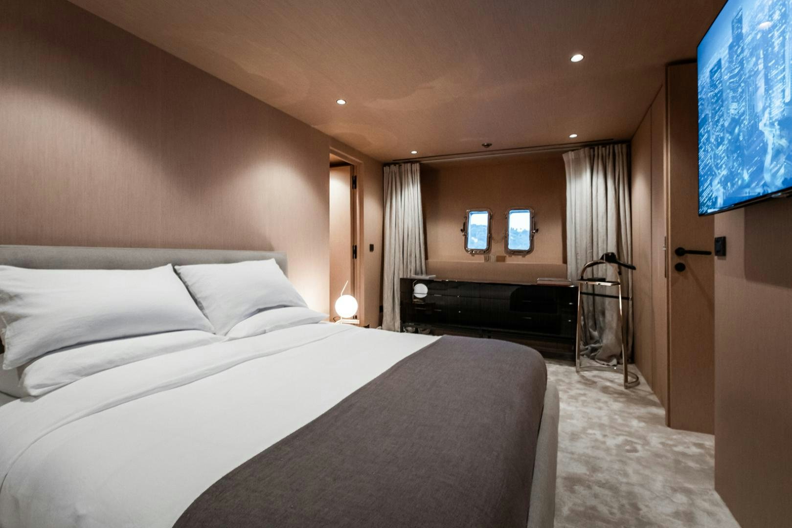 a bedroom with a bed and a window aboard NEOPRENE  Yacht for Sale