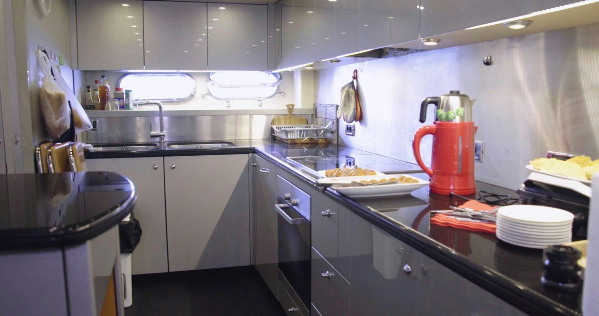 a kitchen with a red mug on the counter aboard LAURA S Yacht for Sale