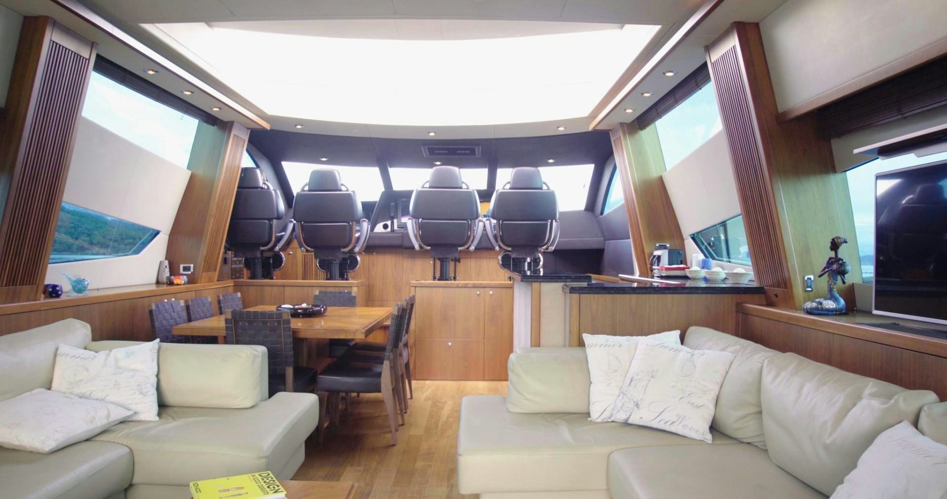 a room with a couch and a table and chairs aboard LAURA S Yacht for Sale