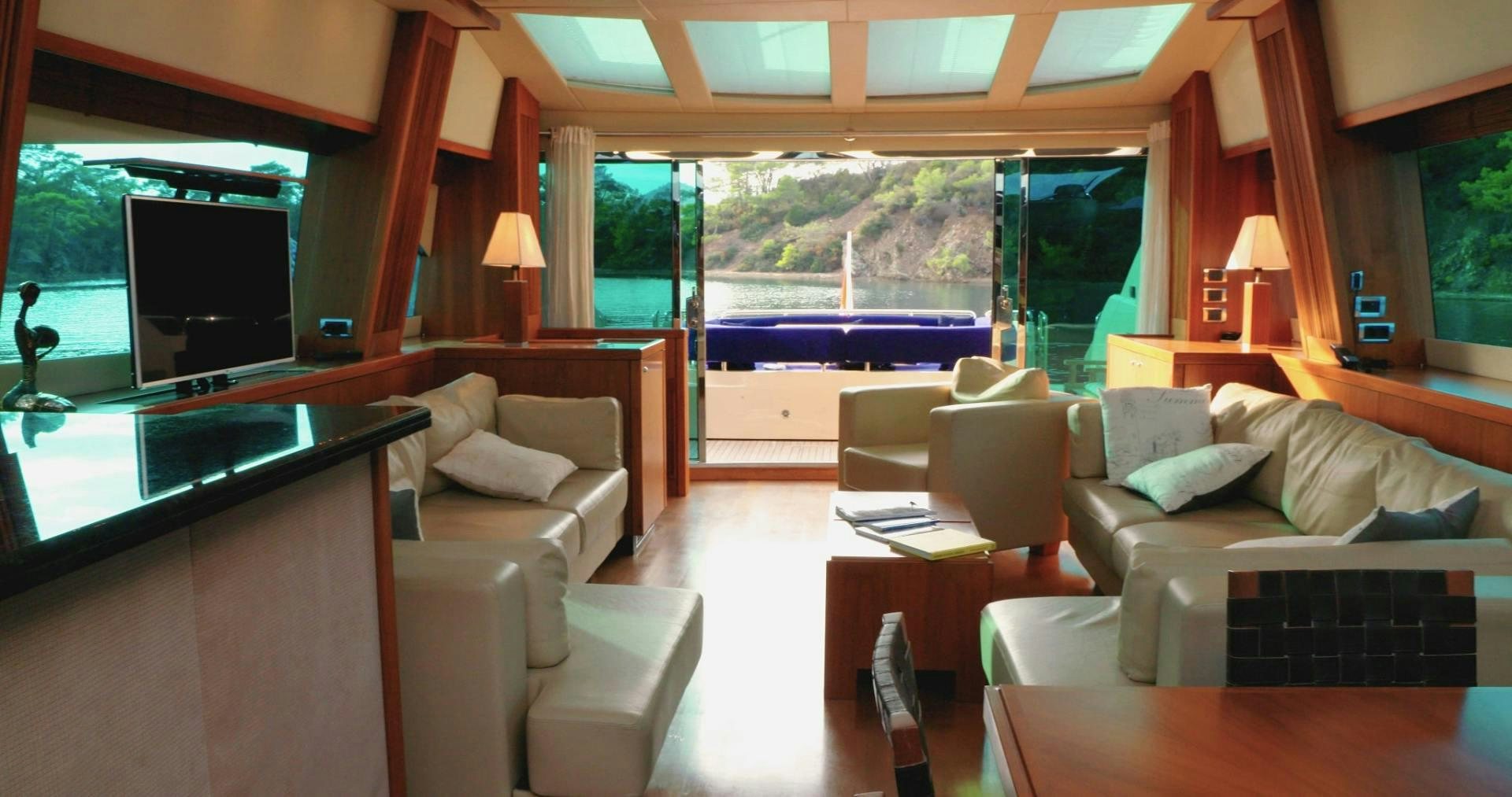 a living room with a large window aboard LAURA S Yacht for Sale