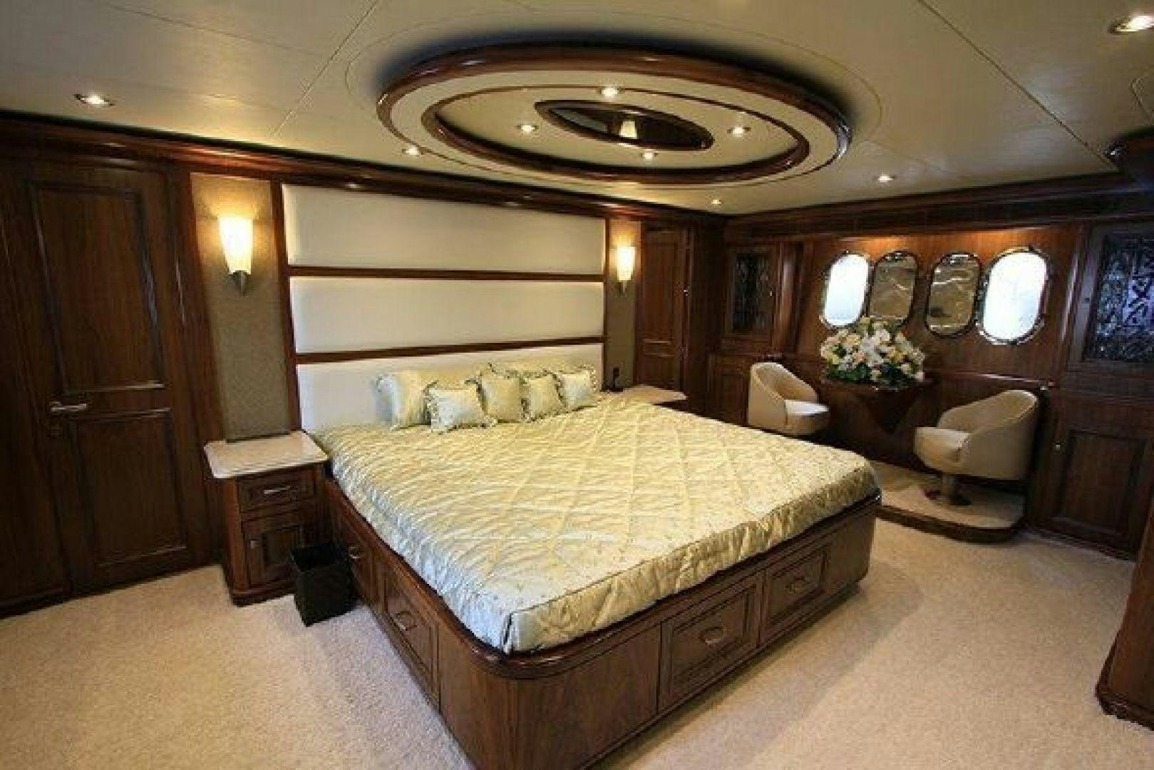 a bedroom with a bed and a mirror aboard WHITE LOTUS VIII Yacht for Sale