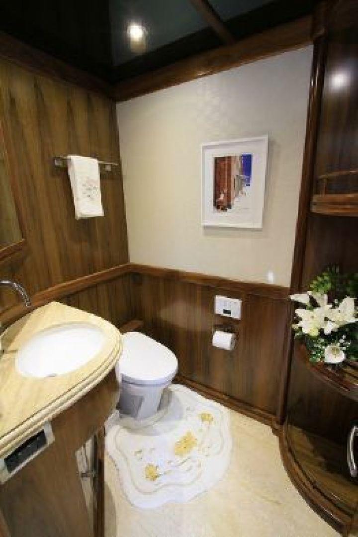 a bathroom with a sink toilet and a mirror aboard WHITE LOTUS VIII Yacht for Sale