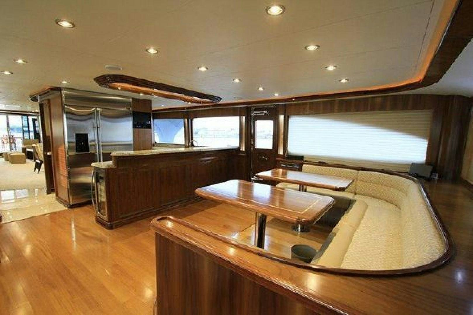 a room with a table and chairs aboard WHITE LOTUS VIII Yacht for Sale