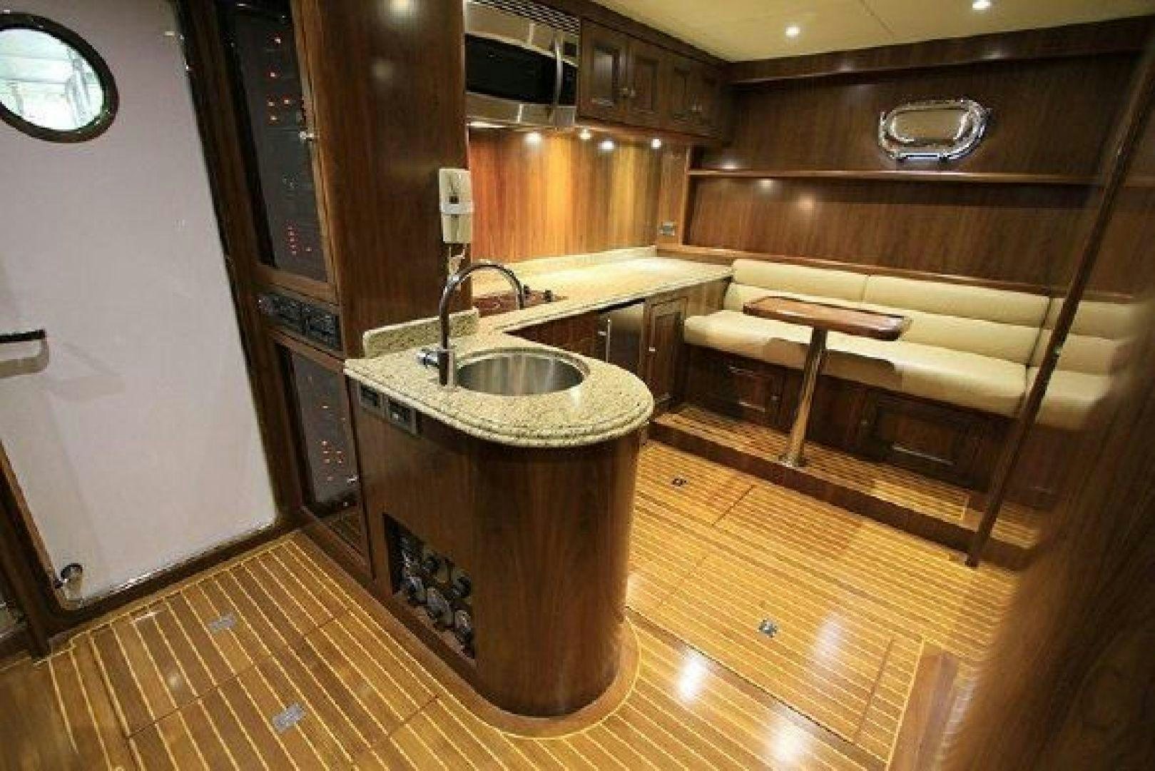 a kitchen with wooden cabinets aboard WHITE LOTUS VIII Yacht for Sale
