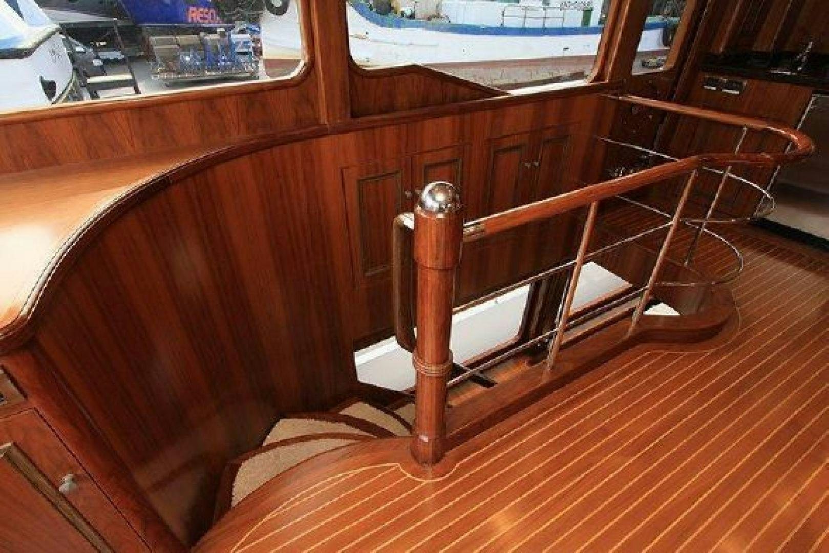 a wooden chair on a wooden floor aboard WHITE LOTUS VIII Yacht for Sale