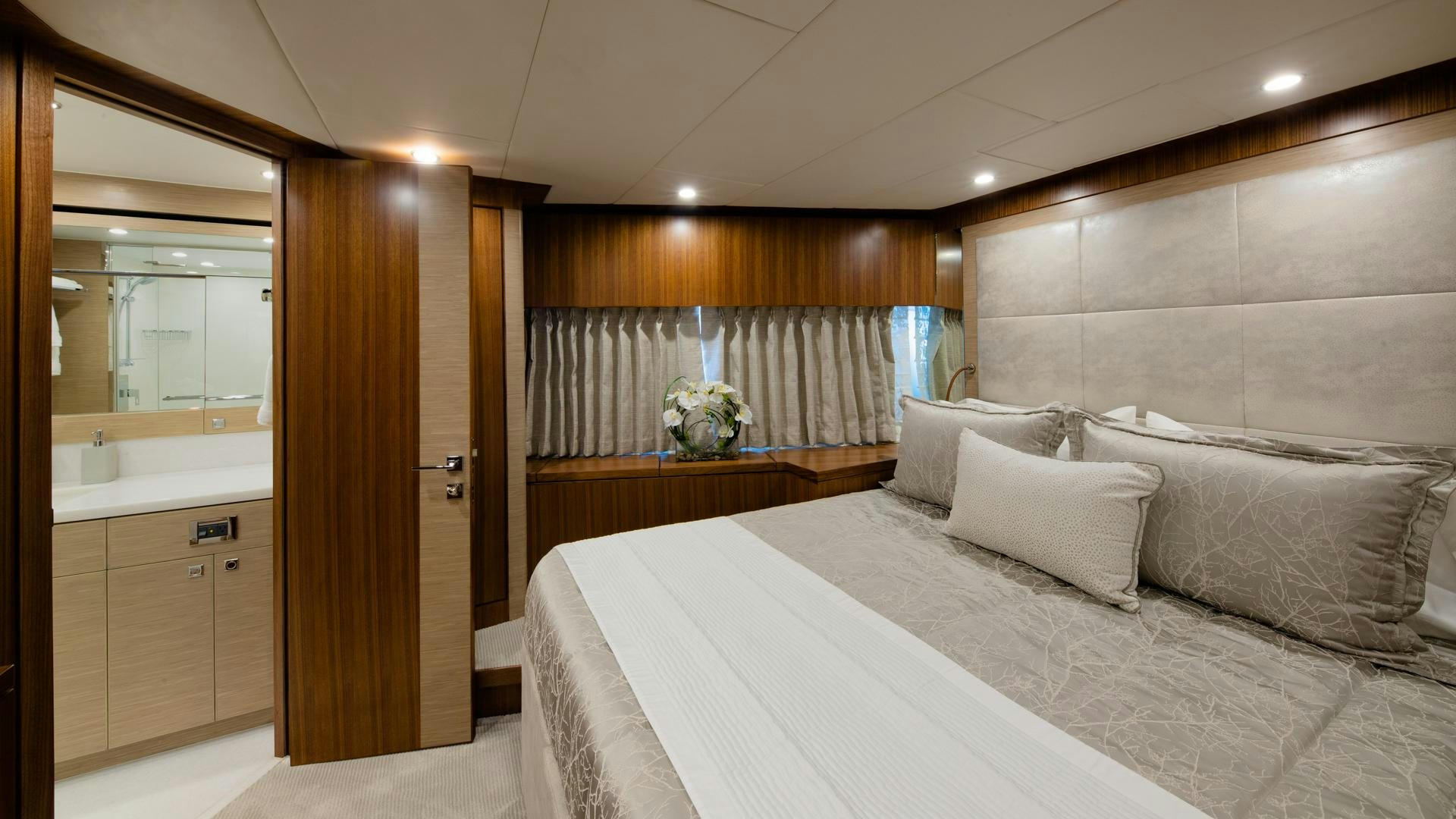 a room with a bed and a mirror aboard RISK TAKER Yacht for Charter