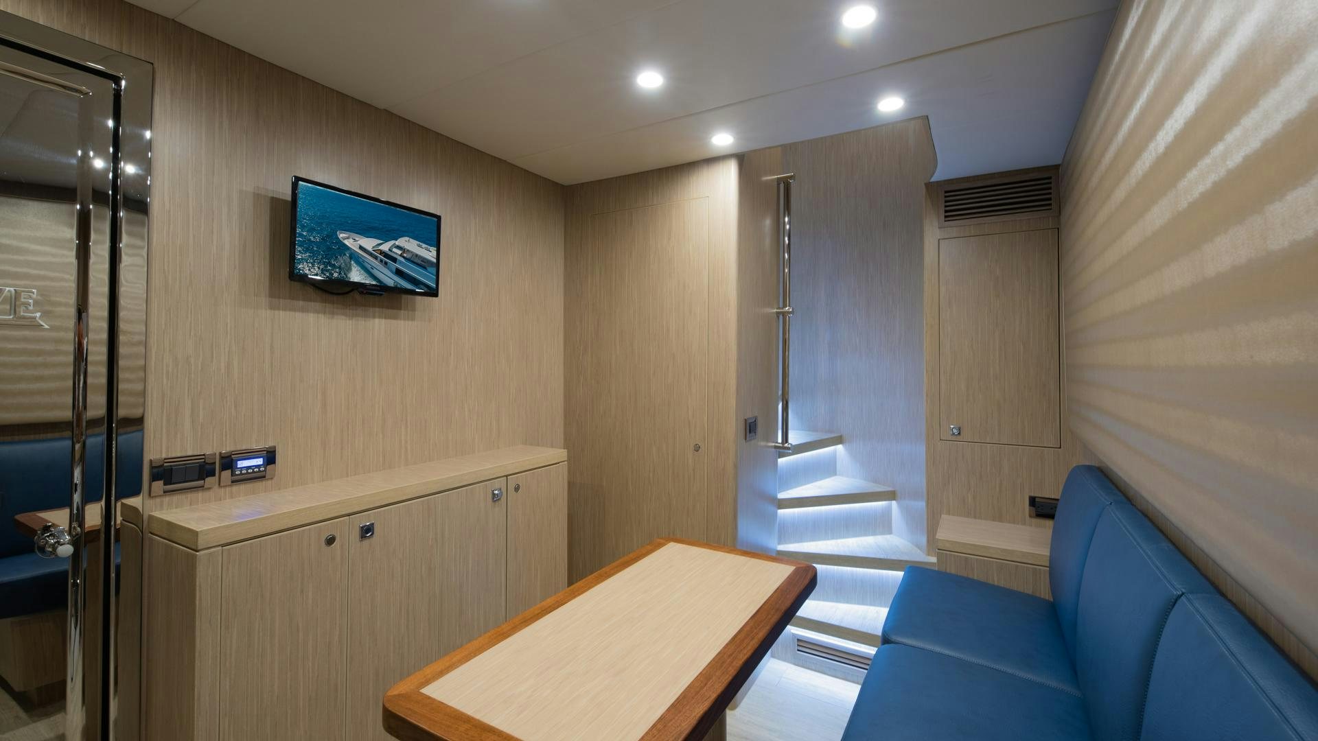 a room with a desk and a tv aboard RISK TAKER Yacht for Charter