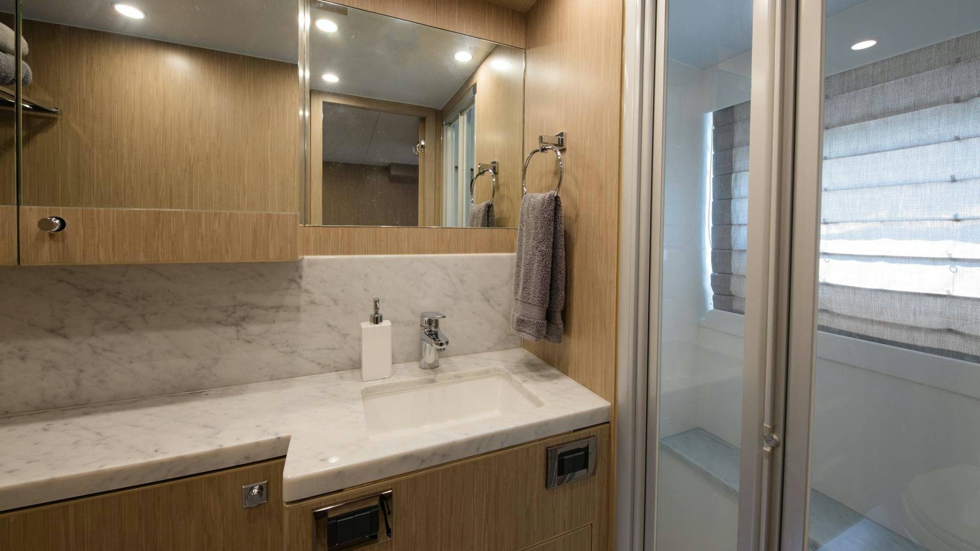 a bathroom with a sink and a mirror aboard RISK TAKER Yacht for Sale
