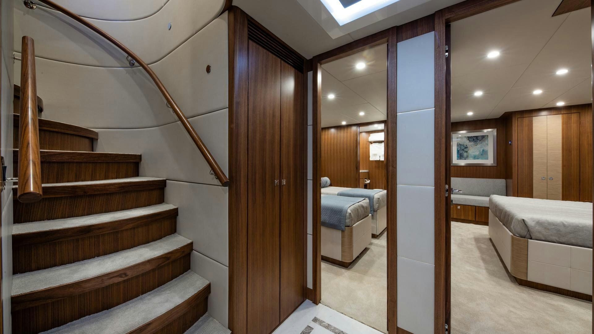 a room with wooden stairs and a bed aboard RISK TAKER Yacht for Sale