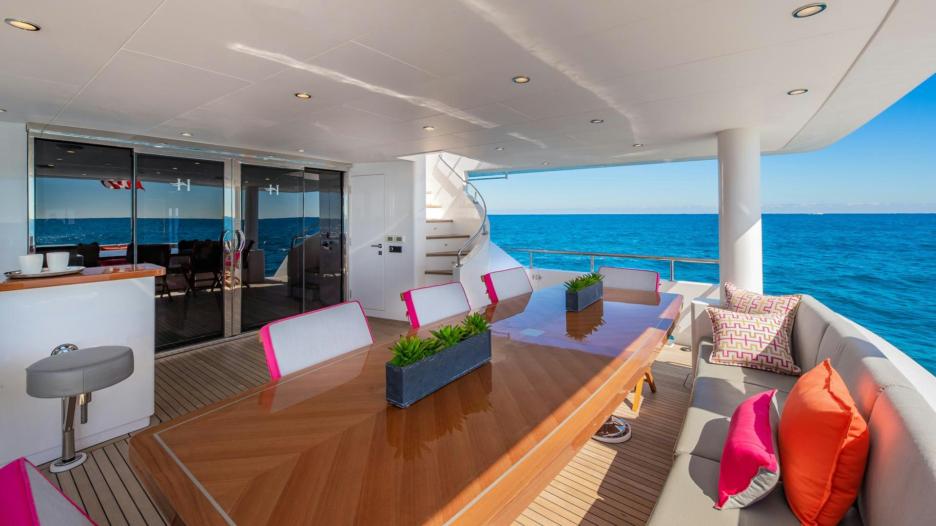 a living room with a large balcony aboard RISK TAKER Yacht for Charter