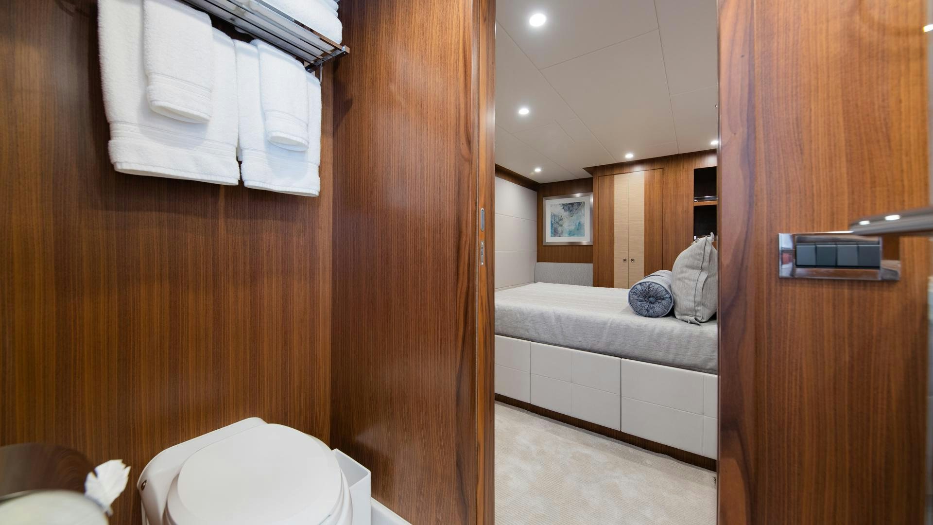 a bathroom with a wood door aboard RISK TAKER Yacht for Sale