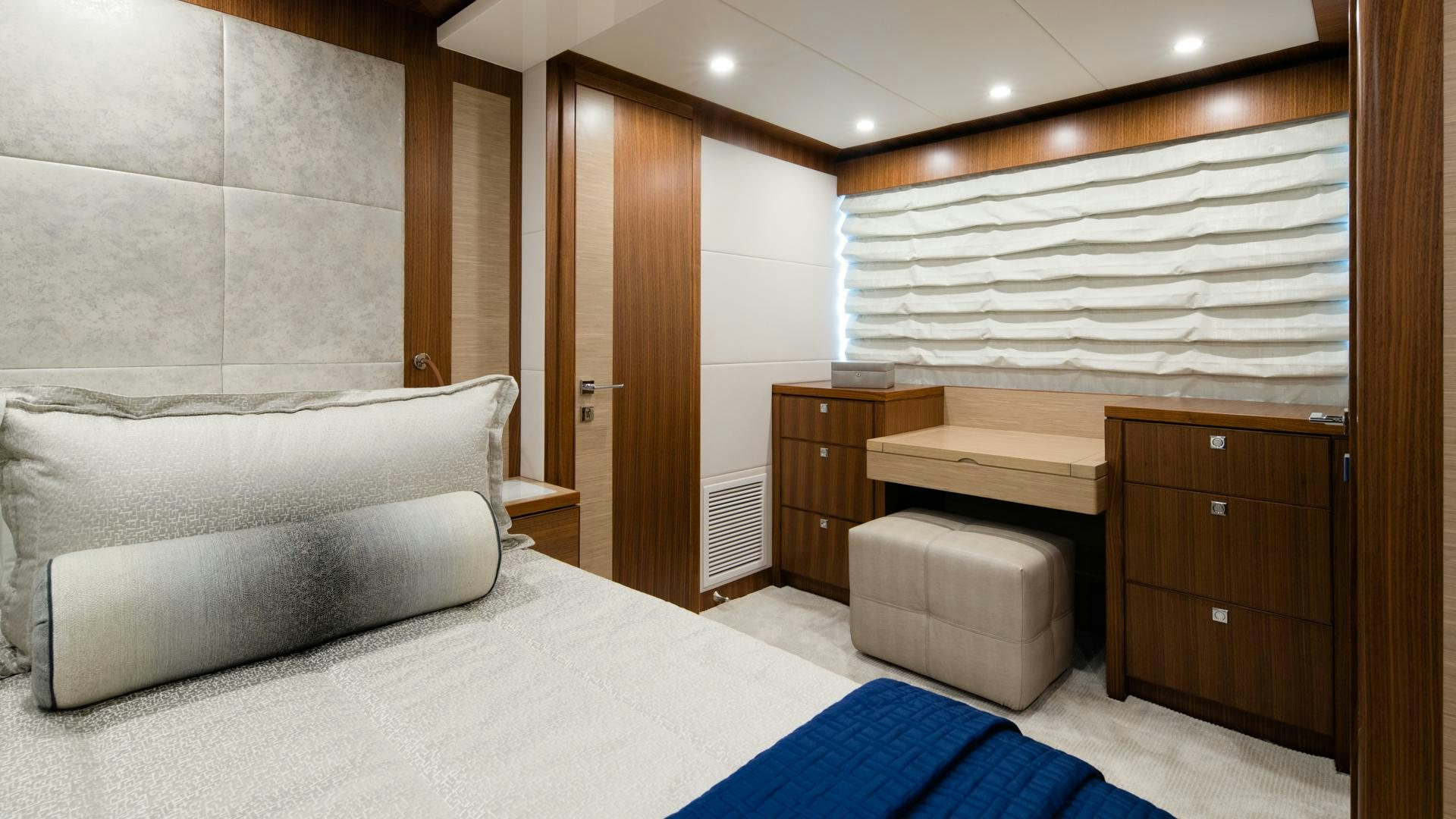 a room with a bed and a desk aboard RISK TAKER Yacht for Sale